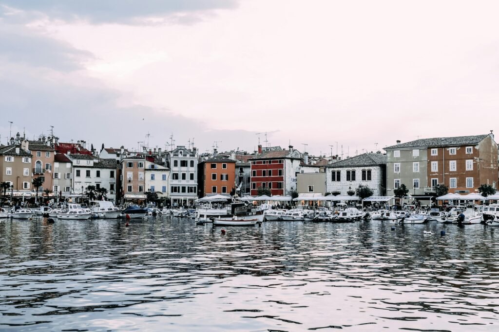 Idyllic waterfront cityscape with boats docked on a serene day.